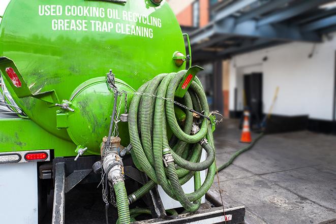 a service truck pumping grease from a restaurant's grease trap in Hayes